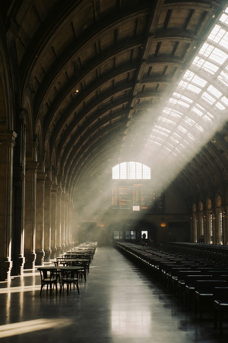 Dramatic Sunbeams Piercing Through the Roof of an Empty Historic Train Station