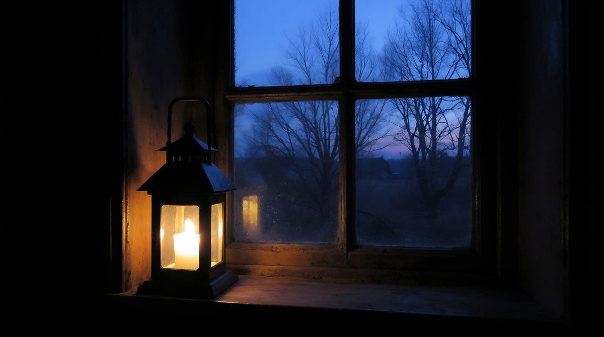 Cozy Candle Lantern on a Rustic Windowsill at Twilight